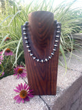 A 14 inch necklace featuring 5 and 12mm sterling silver navajo-style pearls
